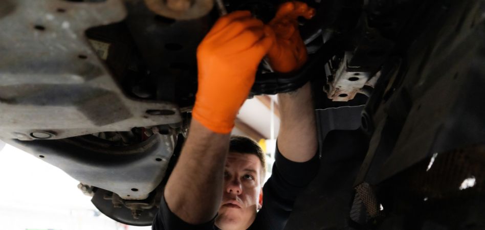 Inspecting a Toyota Camry undercarriage during repair and maintenance