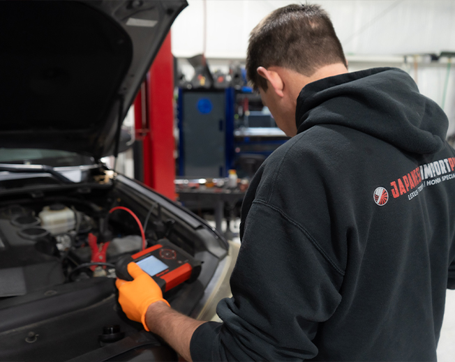 Diagnosing a Japanese vehicle engine with specialized shop equipment